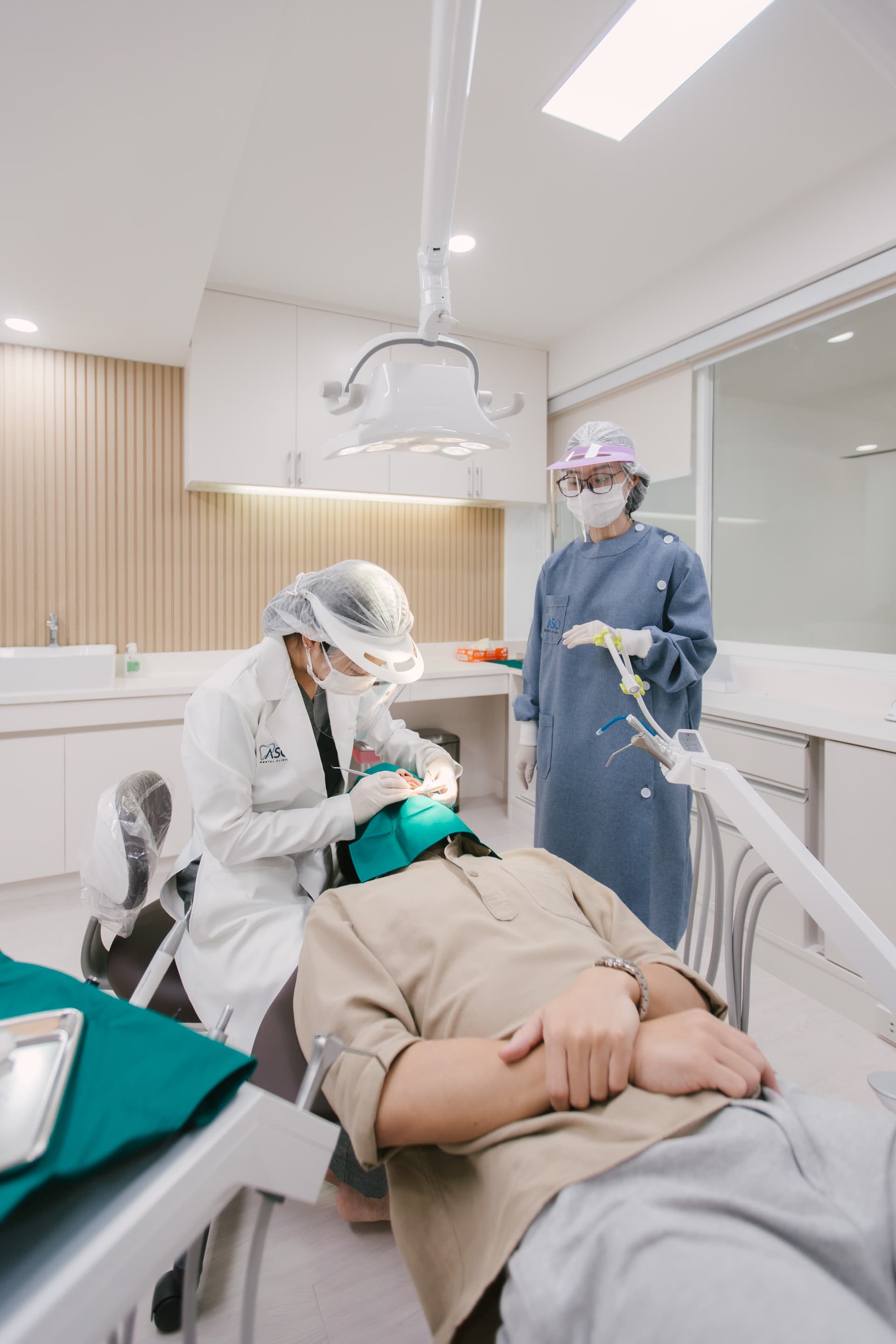 Dentist adjusting overhead dental light