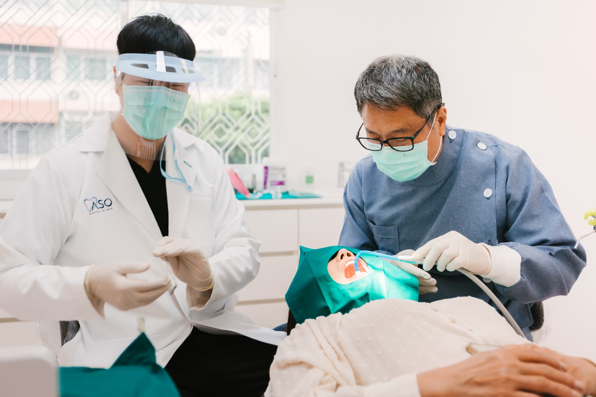 Dentist and assistant during dental treatment